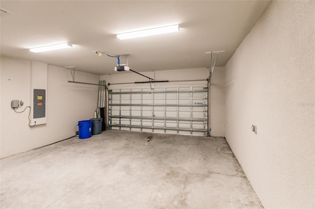 garage featuring electric panel and a garage door opener