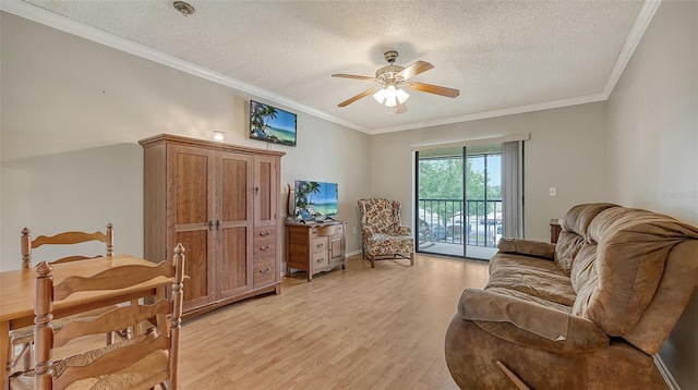 sitting room with light wood-type flooring, ceiling fan, ornamental molding, and a textured ceiling