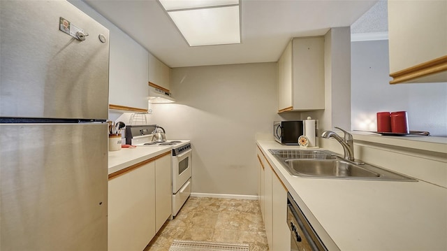 kitchen with a sink, electric stove, ventilation hood, light countertops, and freestanding refrigerator