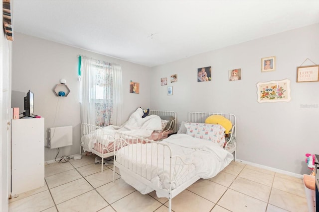 bedroom featuring baseboards and light tile patterned flooring