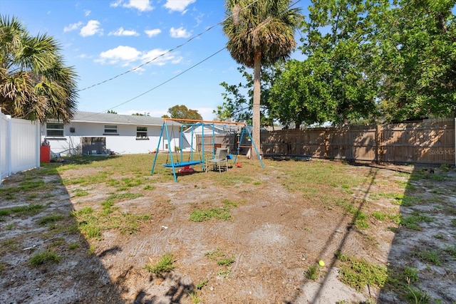 view of yard with a fenced backyard and a playground