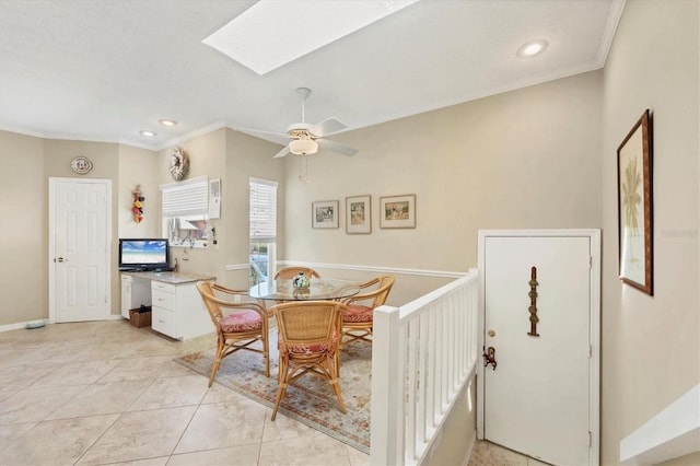 dining room featuring a skylight, light tile patterned floors, ornamental molding, and recessed lighting