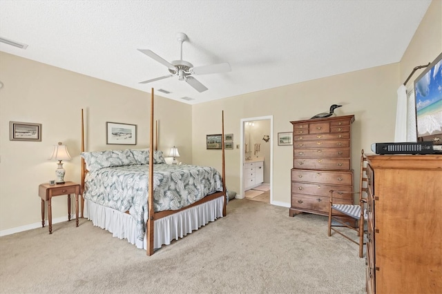 bedroom with a textured ceiling, a ceiling fan, visible vents, and light colored carpet