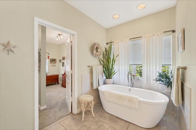 bathroom featuring a freestanding bath and tile patterned floors