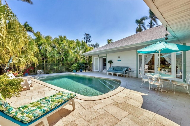 view of pool featuring a fenced in pool, a patio area, fence, and an outdoor living space