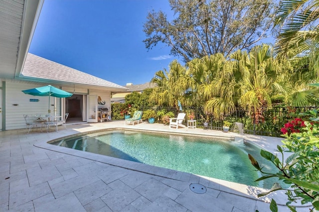 view of pool with fence, area for grilling, a fenced in pool, and a patio