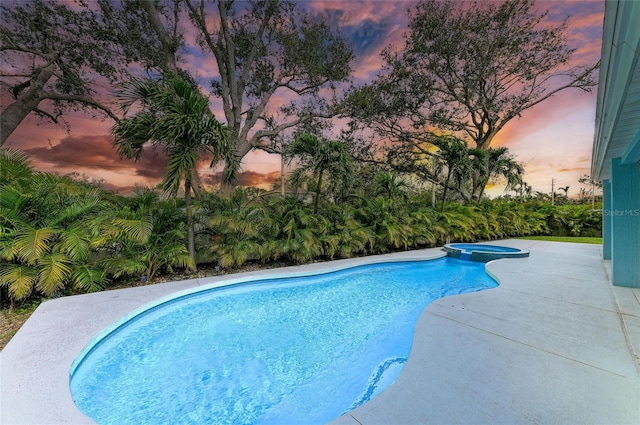 view of pool with a pool with connected hot tub and a patio