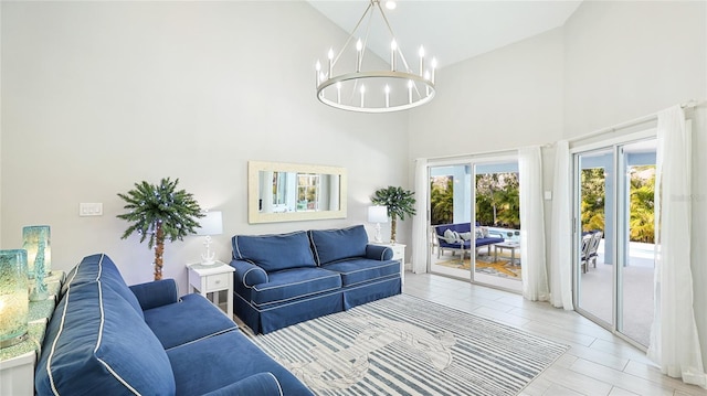 living area featuring high vaulted ceiling and a notable chandelier