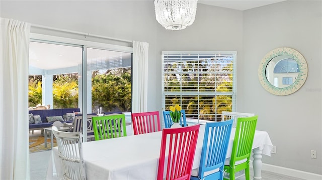 dining space with an inviting chandelier and baseboards