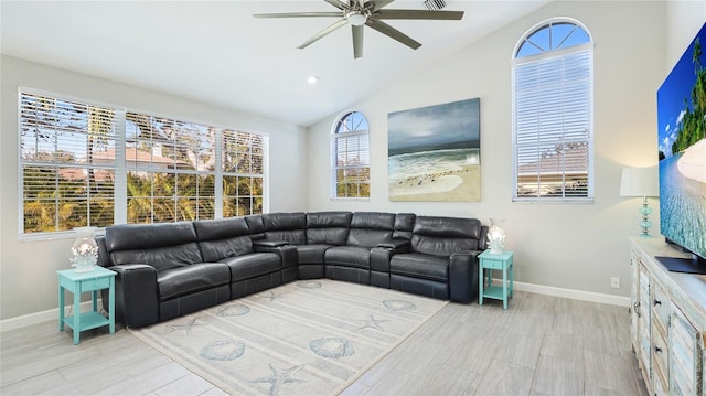 living room featuring baseboards, vaulted ceiling, and a ceiling fan