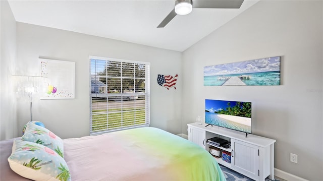 bedroom featuring baseboards, vaulted ceiling, and a ceiling fan