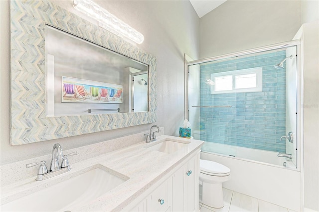 bathroom featuring tile patterned flooring, a sink, toilet, and bath / shower combo with glass door