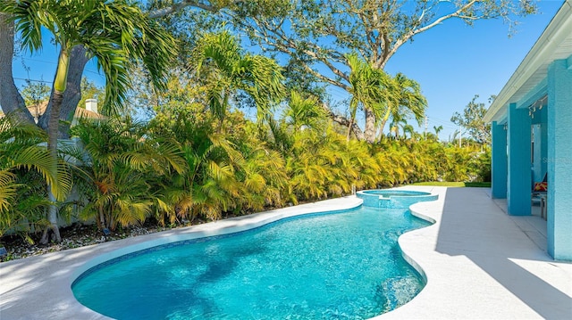 view of pool featuring a patio area and a pool with connected hot tub