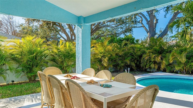 pool featuring outdoor dining space and a patio