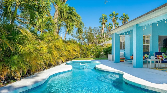 view of swimming pool featuring a patio area and a pool with connected hot tub