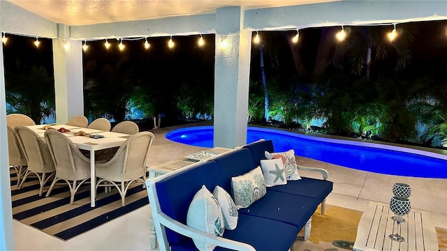 pool featuring outdoor dining space and a patio