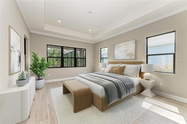 bedroom featuring recessed lighting, light wood-style floors, baseboards, a tray ceiling, and crown molding