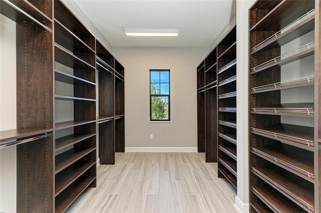 spacious closet with light wood-style flooring