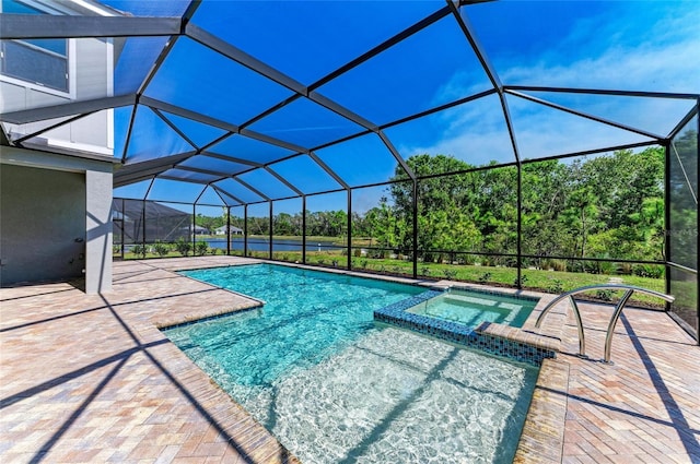 view of pool featuring a pool with connected hot tub, a patio, and a lanai