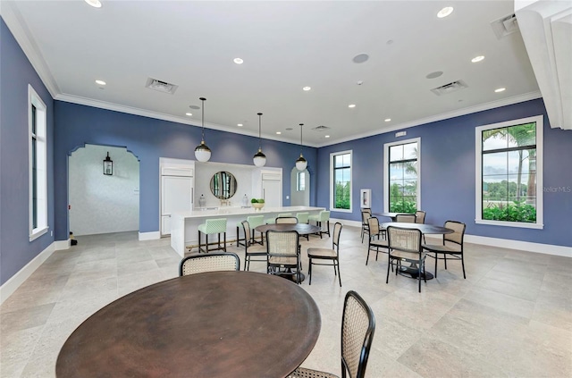 dining area featuring ornamental molding and visible vents