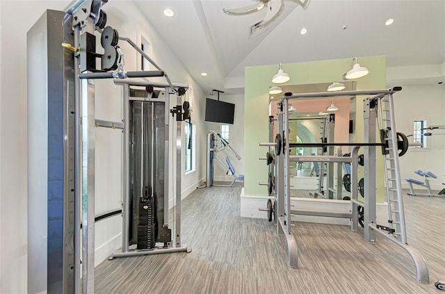 gym with vaulted ceiling, baseboards, wood finished floors, and recessed lighting