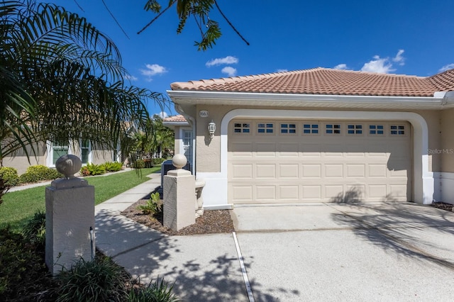 1663 San Silvestro Dr, Venice, FL 34285 - exterior space featuring stucco siding, a garage, driveway, and a tiled roof