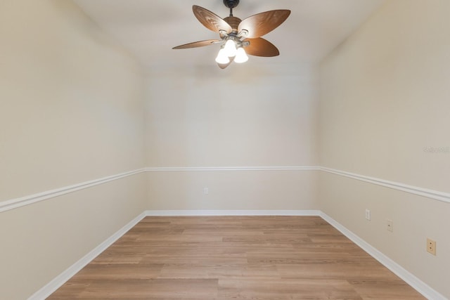 unfurnished room with ceiling fan, light wood-type flooring, and baseboards