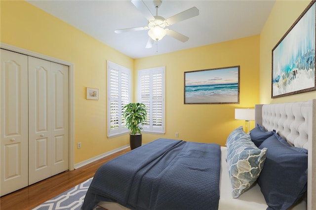 bedroom with ceiling fan, wood finished floors, and baseboards