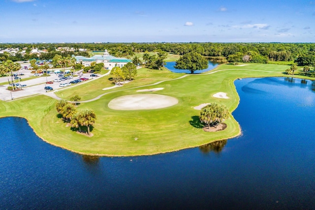 birds eye view of property featuring view of golf course and a water view