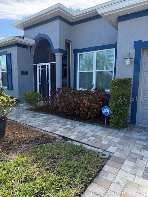 entrance to property featuring stucco siding