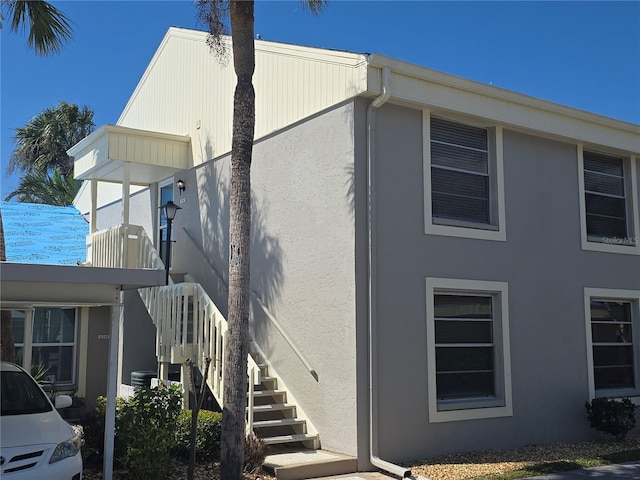 view of home's exterior featuring stairway and stucco siding