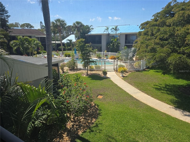 view of yard with fence and a fenced in pool