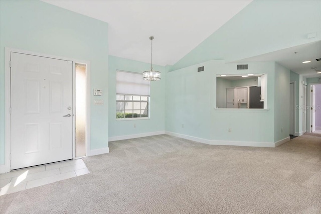 foyer featuring baseboards, carpet, visible vents, and tile patterned flooring