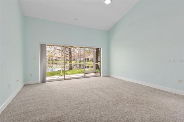 empty room featuring high vaulted ceiling, baseboards, carpet flooring, and recessed lighting