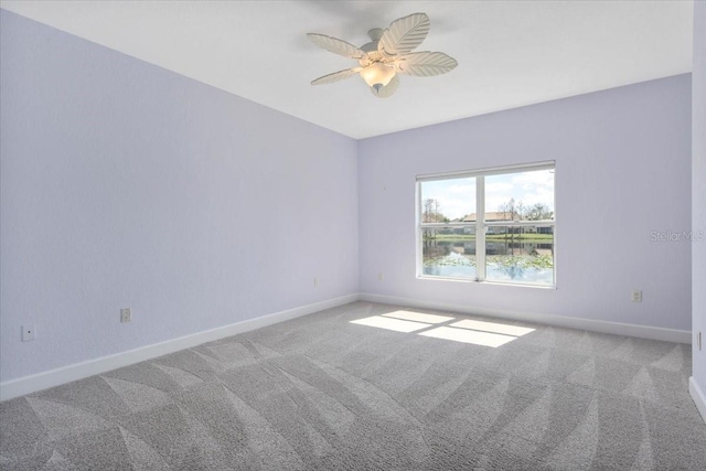 unfurnished room with carpet, ceiling fan, and baseboards