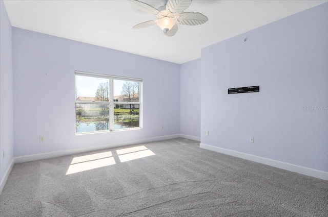 unfurnished room with carpet floors, ceiling fan, and baseboards