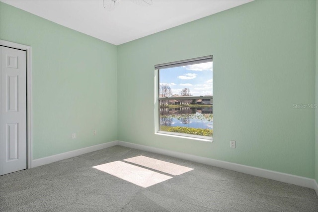 empty room with carpet floors and baseboards