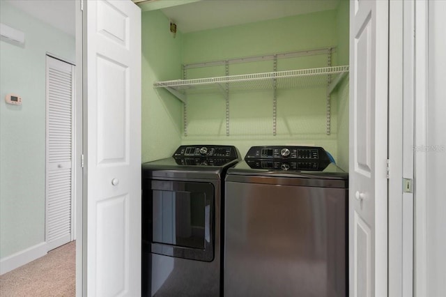 clothes washing area with carpet floors, laundry area, and washing machine and clothes dryer