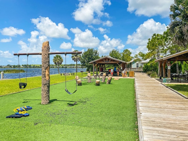 view of home's community with a gazebo, a yard, and a water view