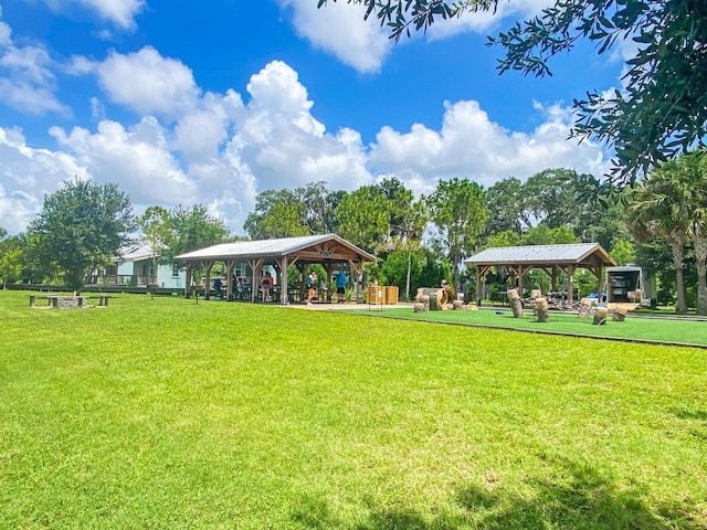 surrounding community with a gazebo and a yard