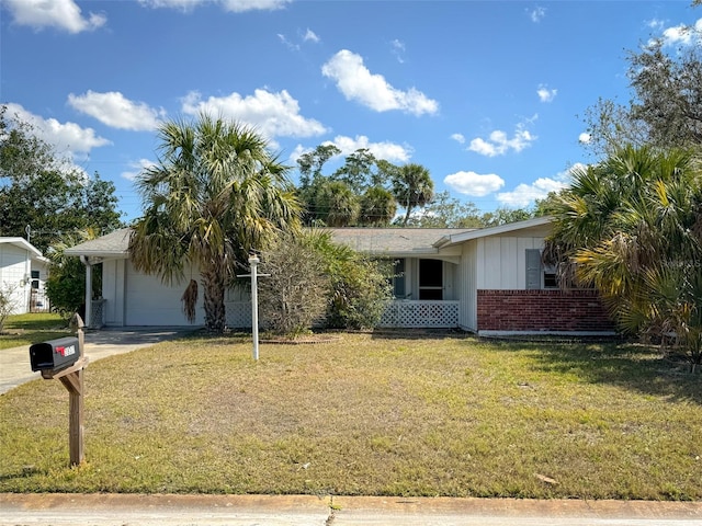 ranch-style home with driveway, a garage, a front lawn, and brick siding