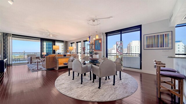 401 S Palm Ave Unit 801, Sarasota, FL 34236 - dining room featuring dark wood-style flooring, baseboards, and expansive windows
