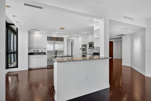 401 S Palm Ave Unit 801, Sarasota, FL 34236 - kitchen with built in appliances, dark wood-style floors, white cabinetry, a peninsula, and open shelves