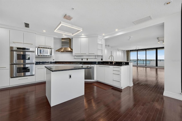 401 S Palm Ave Unit 801, Sarasota, FL 34236 - kitchen with stainless steel appliances, wall chimney exhaust hood, a peninsula, open shelves, and dark countertops