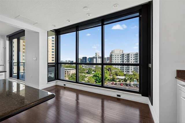 401 S Palm Ave Unit 801, Sarasota, FL 34236 - empty room with a city view, wood finished floors, and a textured ceiling