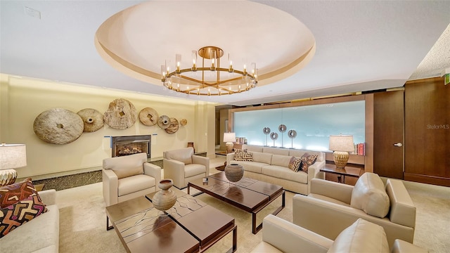 401 S Palm Ave Unit 801, Sarasota, FL 34236 - living area with carpet floors, a chandelier, a tray ceiling, and a lit fireplace