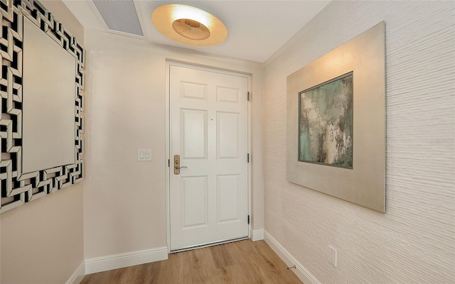 entryway with wood finished floors, visible vents, and baseboards