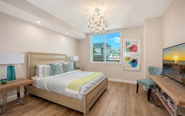 bedroom with an inviting chandelier, light wood-style flooring, baseboards, and recessed lighting