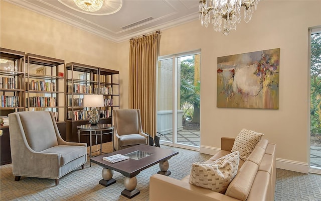 sitting room with a chandelier, visible vents, crown molding, and baseboards