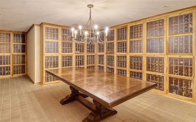 wine cellar with tile patterned flooring and an inviting chandelier